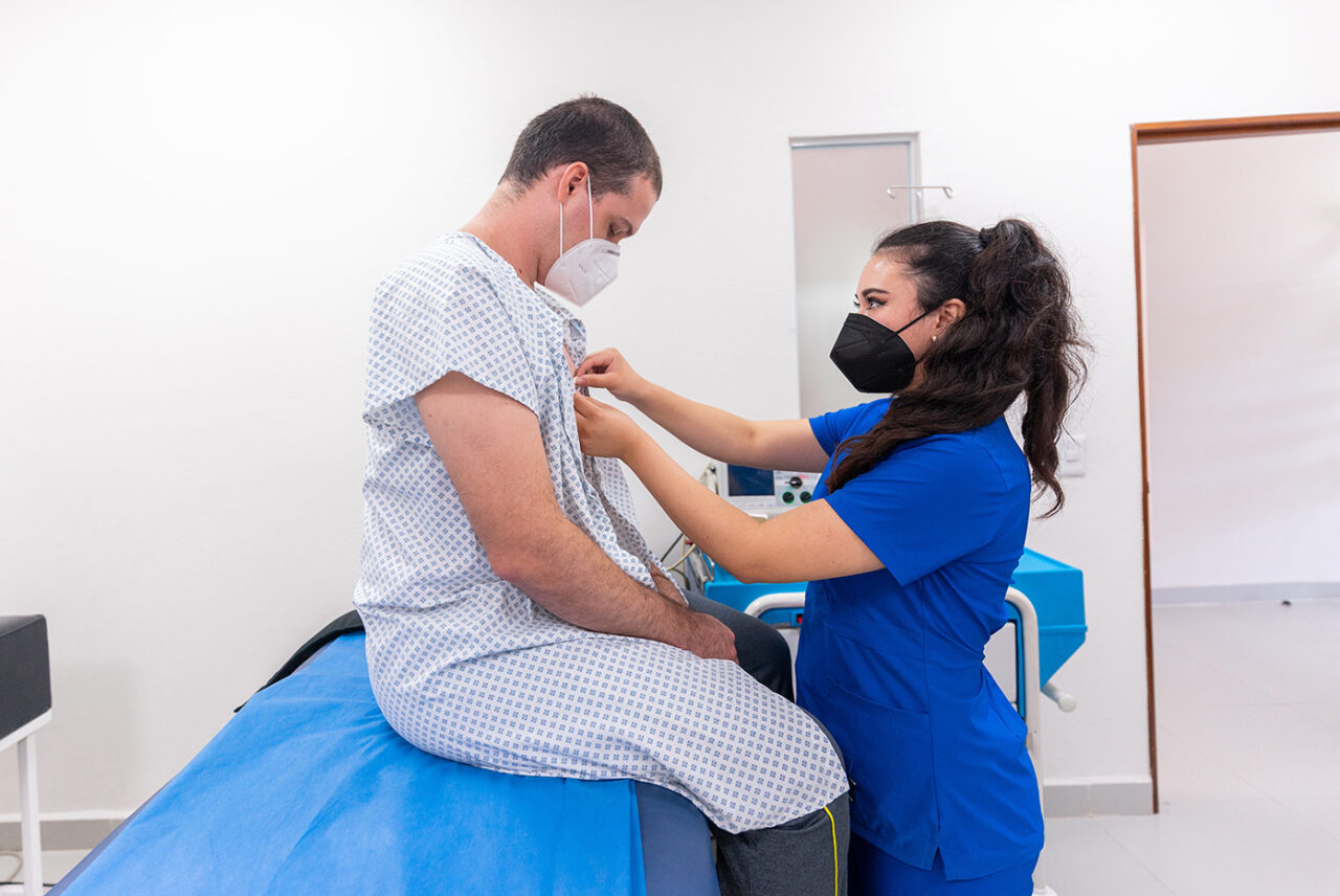 Medical professional examining a patient in a clinical room.