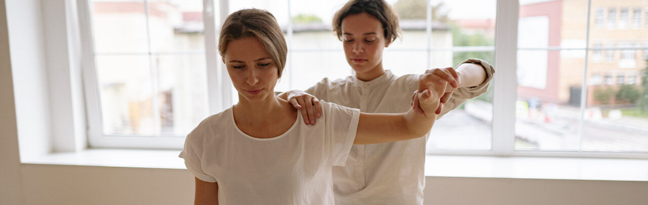 a female physiotherapist examining a female patient