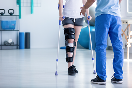 someone in a leg brace undergoing physical therapy