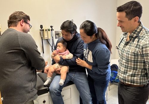 Dr. Dellavedova with patient receiving immunization against RSV